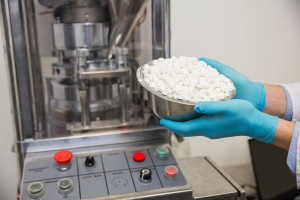 Pharmacist-holding-bowl-of-pills